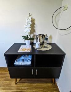 a black cabinet with a plate on top of it at Trébol Hotel in Yurimaguas