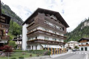 a large building with balconies on the side of a street at Hotel Venezia in Rocca Pietore