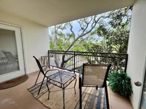 a balcony with two chairs and a table at Seaside Treasure in Biloxi
