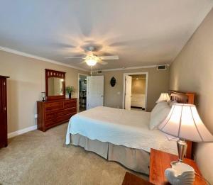 a bedroom with a bed and a ceiling fan at Seaside Treasure in Biloxi