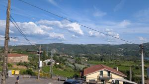 a person standing on a hill with a view at Casa da Cerca in Cenlle