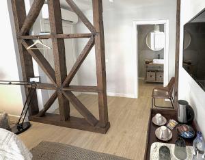 a living room with a large wooden door in a room at Bairro House Lisbon Charming Suites in Lisbon +47 photos