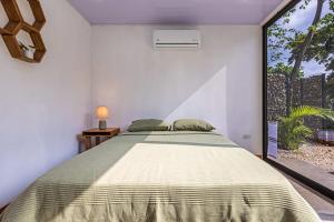 a bedroom with a bed and a large window at Z orro Tropical in Arbolito +40 photos