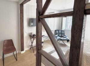 a living room with a chair and a table at Bairro House Lisbon Charming Suites in Lisbon