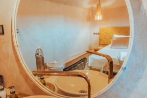 a bathroom with a sink and a mirror at Kidal Luxury Camp in Adrouine