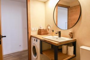a bathroom with a sink and a mirror at Apartaments Bellreguard in Papiol +30 photos