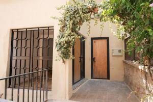 an entrance to a house with a wooden door at Apartaments Bellreguard in Papiol