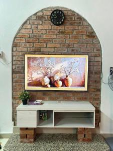 a brick wall with a painting of vases at Rumah Singgah in Bentong