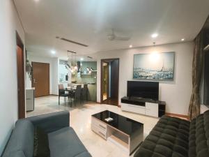 a living room with a couch and a dining room at Vortex Suites KLCC by Chia in Kuala Lumpur