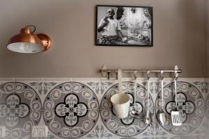a bathroom with a wall with a picture on the wall at Il Ciabattino di Ceva in Ceva +22 photos