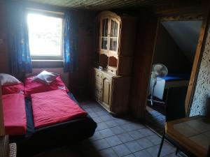 a small bedroom with a bed and a window at ANEMA Ferienwohnung in Bayerisch Eisenstein
