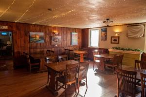 a dining room with wooden tables and chairs at The Cove Inn in Westport
