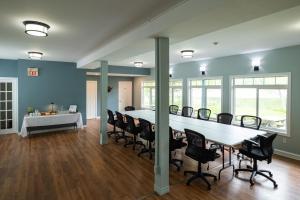 a conference room with a long table and chairs at The Cove Inn in Westport