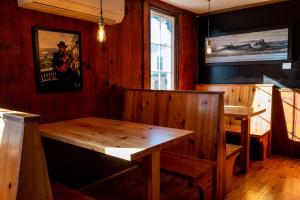 a dining room with a wooden table and a window at The Cove Inn in Westport