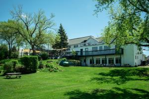 a large white house with a large yard at The Cove Inn in Westport