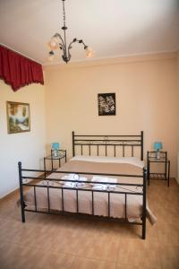 a bedroom with a bed and two side tables at Irida Suite in Salamina