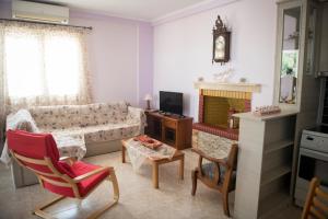 a living room with a couch and a fireplace at Irida Suite in Salamina