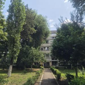 an apartment building with trees in front of it at Apartament Stephen in Constanţa