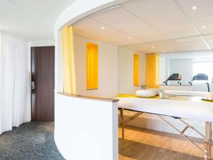 a room with a sink and a mirror at Novotel Bordeaux Lac in Bordeaux +150 photos