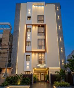 a white building with a sign in front of it at Jay & Jas Hotel in Tirupati