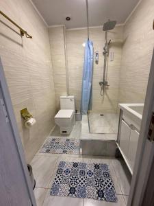a bathroom with a toilet and a shower and a sink at Anor Avenue Hotel in Tashkent
