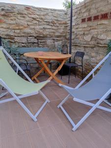 two chairs and a wooden table and two chairs at E2 Residence in Balchik