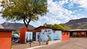 a building with a mural on it with mountains in the background at Copper Mountain Motel in Superior