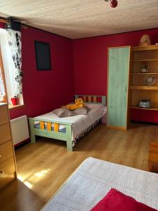 a bedroom with a bed with a teddy bear on it at Chez Phil et Marie in Pralong