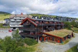 a large building with a grass roof at Cozy Mountain Beito - 18 sengeplasser - bilijard in Beitostøl