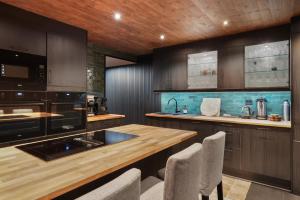 a kitchen with wooden cabinets and a wooden counter top at Cozy Mountain Beito - 18 sengeplasser - bilijard in Beitostøl