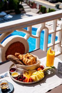 a plate of food on a table with fruit and vegetables at Saint George Palace Hotel All-inclusive in Sveti Vlas