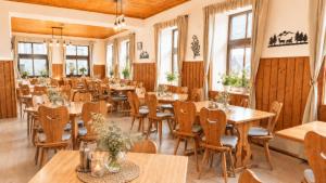 a large dining room with tables and chairs at Penzion Na Rozcestí in Janov nad Nisou