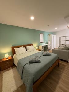 a bedroom with a large bed and a couch at Casa das Flores in Sardoal