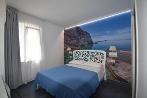 a bedroom with a bed with a view of the ocean at AzzurroMare Ponza Rooms Sea View by Caseaponza it in Ponza