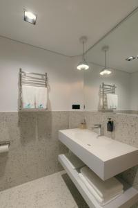 a bathroom with a white sink and a mirror at Proza Hotel & Restaurant in Kutaisi +49 photos