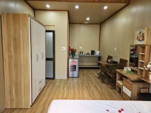 a room with a kitchen and a dining room with a table at Mai House Homestay - Long-term rental in Hoi An, Da Nang in Thanh Ðông (1) +3 photos