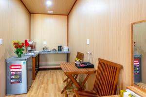 a small kitchen with a table and a counter at Mai House Homestay - Long-term rental in Hoi An, Da Nang in Thanh Ðông (1)
