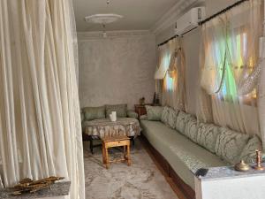 a living room with a couch and a table at Villa route ourzazate in Aït Ourir