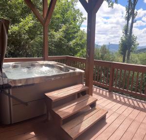a hot tub on the deck of a cabin at Fox Crossing in Banner Elk
