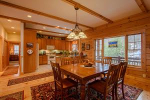 a kitchen and dining room with a wooden table and chairs at Fox Crossing in Banner Elk