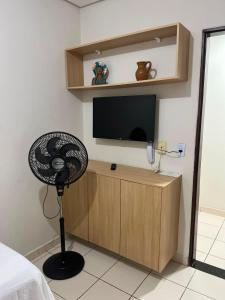 a room with a fan and a flat screen tv at Hotel Piracema Caruaru in Caruaru +10 photos