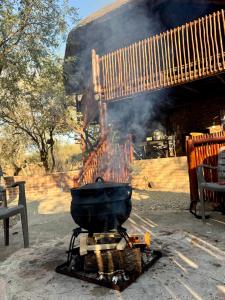 a grill with a pan on top of it at Zaganaga Kruger Lodge in Marloth Park