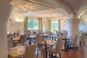 a dining room with wooden tables and chairs at Le Domaine de Falgos Golf & Spa in Saint-Laurent-de-Cerdans