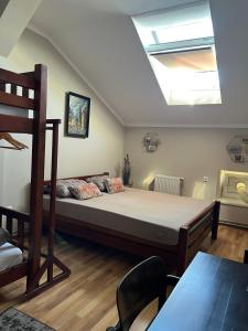 a bedroom with a large bed and a skylight at Lions Heart Hostel in Lviv
