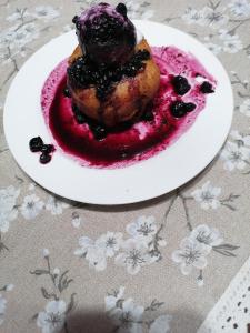 a plate of food with a dessert on a table at Sófalvi Vendégház in Sîntimbru