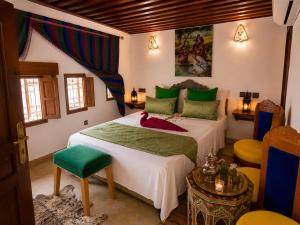 a bedroom with a large bed in a room at Riad Hamad Tijani in Fez