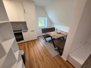 a small kitchen with a table and a dining room at HeideSuite Soltau in Soltau