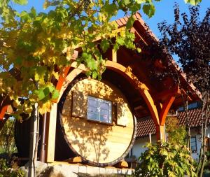 a house with a large wheel on the side of it at Ferienwohnung am Rebhang in Sasbachwalden +4 photos