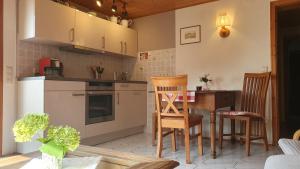 a kitchen with a table and chairs in a room at Ferienwohnung am Rebhang in Sasbachwalden