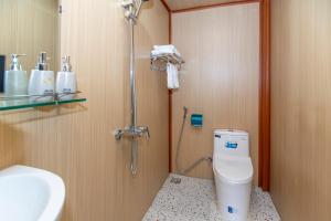 a bathroom with a shower and a toilet and a sink at Mai House Homestay - Long-term rental in Hoi An, Da Nang in Thanh Ðông (1)